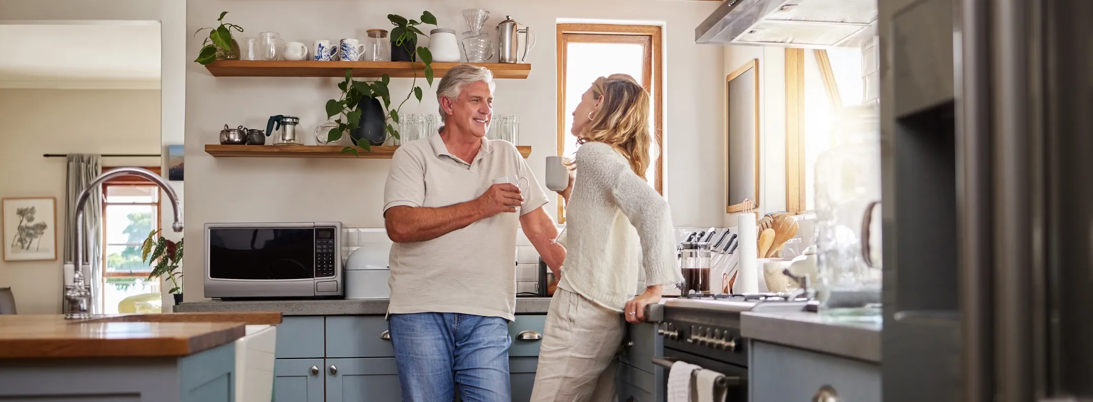 middle aged husband and wife in north carolina kitchen drinking coffee